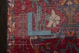 Backside of handmade 2000s Shiraz rug showing knot structure and weave density