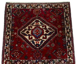 Surface texture of 2000s Shiraz rug with natural Wool and intricate pattern