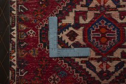 Backside of handmade 2000s Shiraz rug showing knot structure and weave density