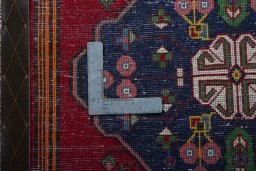 Backside of handmade 2000s Shiraz rug showing knot structure and weave density