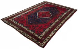 Corner detail of 2000s Shiraz rug showing border pattern and Wool pile