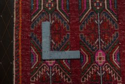 Backside of handmade 2000s Shiraz rug showing knot structure and weave density