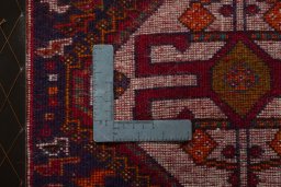 Backside of handmade 2000s Shiraz rug showing knot structure and weave density
