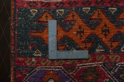 Backside of handmade 2000s Shiraz rug showing knot structure and weave density