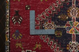 Backside of handmade 2000s Shiraz rug showing knot structure and weave density