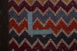 Backside of handmade 2000s Shiraz rug showing knot structure and weave density