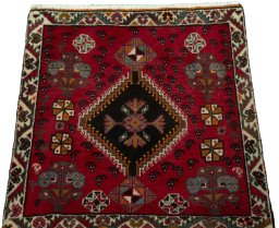 Surface texture of 2000s Shiraz rug with natural Wool and intricate pattern