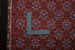 Backside of handmade 2000s Shiraz rug showing knot structure and weave density