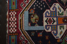 Backside of handmade 2000s Shiraz rug showing knot structure and weave density
