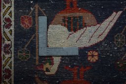 Backside of handmade 2000s Shiraz rug showing knot structure and weave density