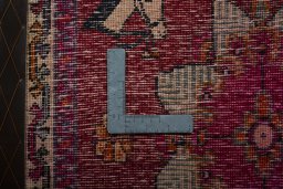 Backside of handmade 2000s Shiraz rug showing knot structure and weave density