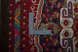 Backside of handmade 2000s Shiraz rug showing knot structure and weave density