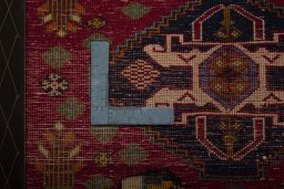 Backside of handmade 2000s Shiraz rug showing knot structure and weave density