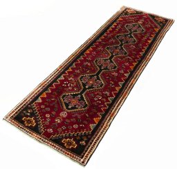 Corner detail of 2000s Shiraz rug showing border pattern and Wool pile