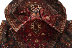 Corner detail of 2000s Shiraz rug showing border pattern and Wool pile