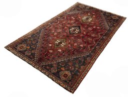 Corner detail of 2000s Shiraz rug showing border pattern and Wool pile