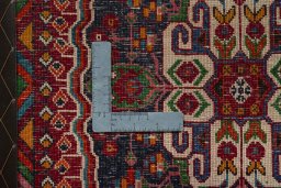 Backside of handmade 2000s Shiraz rug showing knot structure and weave density