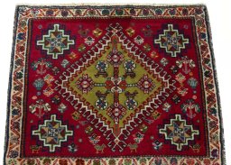 Surface texture of 2000s Shiraz rug with natural Wool and intricate pattern