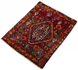 Corner detail of 2000s Shiraz rug showing border pattern and Wool pile