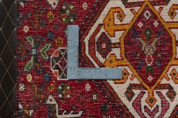 Backside of handmade 2000s Shiraz rug showing knot structure and weave density