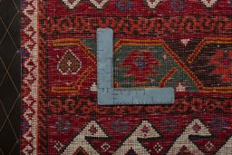 Backside of handmade 2000s Shiraz rug showing knot structure and weave density