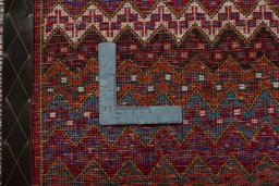 Backside of handmade 2000s Shiraz rug showing knot structure and weave density