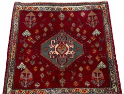 Surface texture of 2000s Shiraz rug with natural Wool and intricate pattern