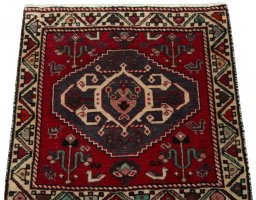 Surface texture of 2000s Shiraz rug with natural Wool and intricate pattern