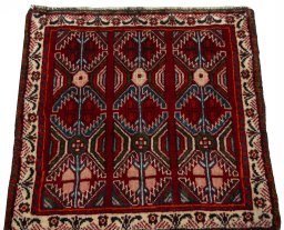 Surface texture of 2000s Shiraz rug with natural Wool and intricate pattern