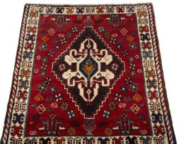 Surface texture of 2000s Shiraz rug with natural Wool and intricate pattern