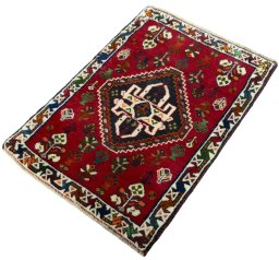 Corner detail of 2000s Shiraz rug showing border pattern and Wool pile