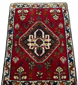 Surface texture of 2000s Shiraz rug with natural Wool and intricate pattern
