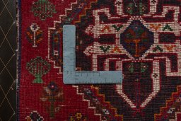 Backside of handmade 2000s Shiraz rug showing knot structure and weave density