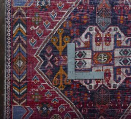 Backside of handmade 2000s Shiraz rug showing knot structure and weave density