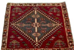Surface texture of 2000s Shiraz rug with natural Wool and intricate pattern