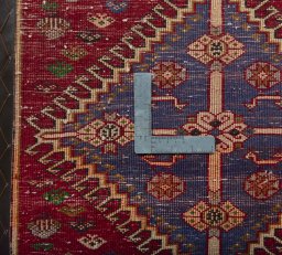 Backside of handmade 2000s Shiraz rug showing knot structure and weave density
