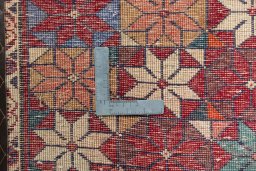 Backside of handmade 2000s Shiraz rug showing knot structure and weave density