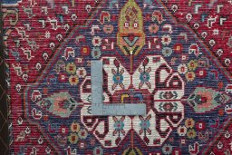 Backside of handmade 2000s Shiraz rug showing knot structure and weave density