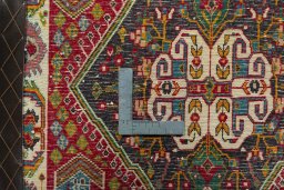Backside of handmade 2000s Shiraz rug showing knot structure and weave density