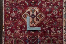 Backside of handmade 2000s Shiraz rug showing knot structure and weave density