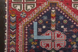 Backside of handmade 2000s Shiraz rug showing knot structure and weave density