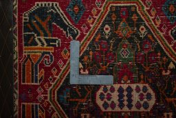 Backside of handmade 2000s Shiraz rug showing knot structure and weave density