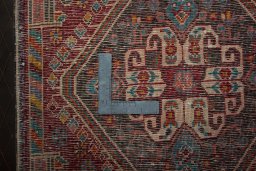 Backside of handmade 2000s Shiraz rug showing knot structure and weave density