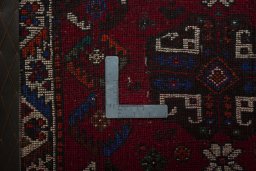 Backside of handmade 2000s Shiraz rug showing knot structure and weave density