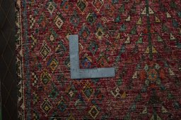 Backside of handmade 2000s Shiraz rug showing knot structure and weave density