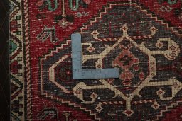 Backside of handmade 2000s Shiraz rug showing knot structure and weave density