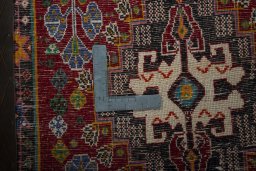 Backside of handmade 2000s Shiraz rug showing knot structure and weave density