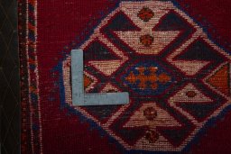 Backside of handmade 2000s Shiraz rug showing knot structure and weave density