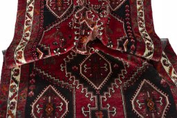 Corner detail of 2000s Shiraz rug showing border pattern and Wool pile