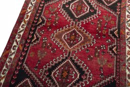 Backside of handmade 2000s Shiraz rug showing knot structure and weave density